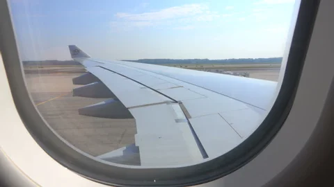 photo of the left side wing on a plane from passenger window 